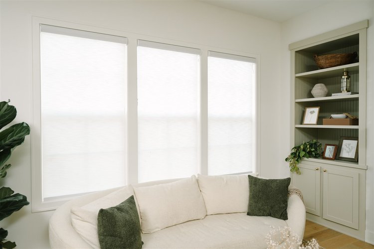 Indoor roller shades behind a couch.